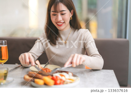 Joyful adult business asian single woman eating lunch tasty menu elegant foodie happy lifestyle 133637616