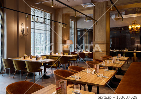 comfortable space with refined details, open restaurant space with ambient lighting and sophisticated decor 133637629