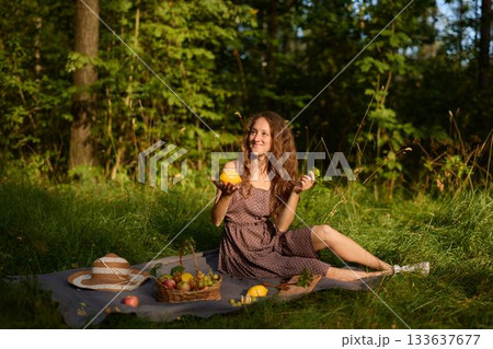 Joyful lady holding lemon, Woman on picnic enjoying citrus Joyful lady holding lemon, Woman on picnic enjoying citrus 133637677