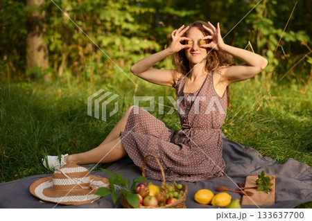 Young woman arranging farmhouse style picnic with seasonal produce Young woman arranging farmhouse style picnic with seasonal produce 133637700