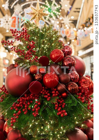 Elegant seasonal ornament centerpiece arrangement, Charming festive display with lights and berries 133637743