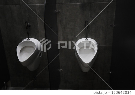 Urinal on a gray marble wall background Urinal on a gray marble wall background 133642034