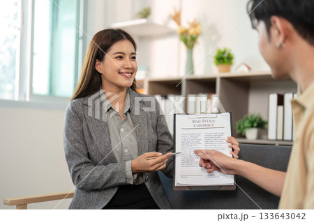 Real Estate Agent Presenting Contract to Client Real Estate Agent Presenting Contract to Client 133643042