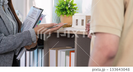 Real estate agent discussing property details with client Real estate agent discussing property details with client 133643048