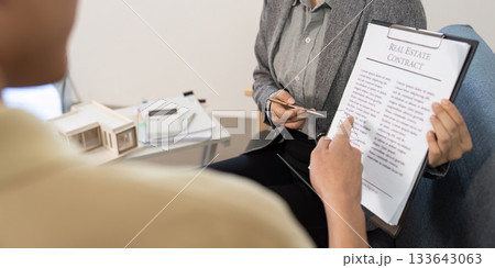 Real Estate Agent Discussing Contract with Client Real Estate Agent Discussing Contract with Client 133643063
