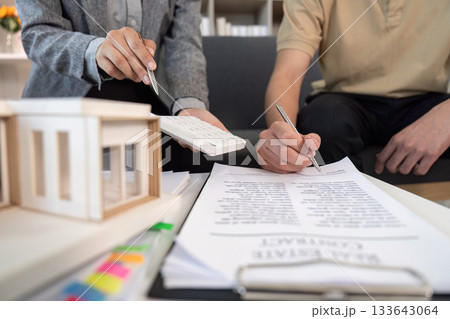 Real Estate Agent Assisting Client with Paperwork 133643064