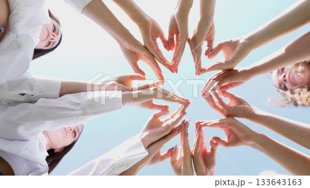 A beautifully creative arrangement of various hands forming heart shapes, symbolizing unity and teamwork A beautifully creative arrangement of various hands forming heart shapes, symbolizing unity and teamwork 133643163