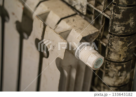 A used white oil battery from a house 133643182
