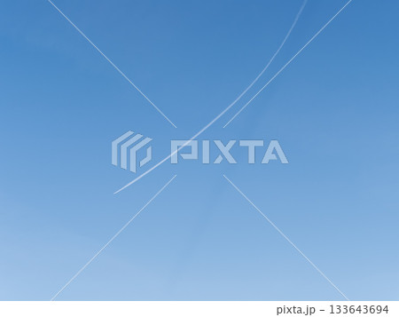 Blue sky with airplane trails and clouds. 133643694