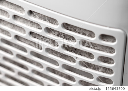 Dust clogged air purifier filter. Dirty used HVAC element. Home appliance component 133643800