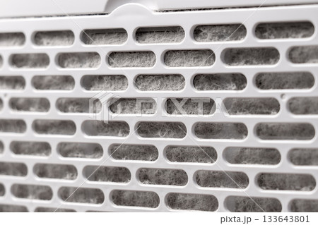 Plastic filter of home air conditioning appliance contaminated with grey house dust fibres 133643801