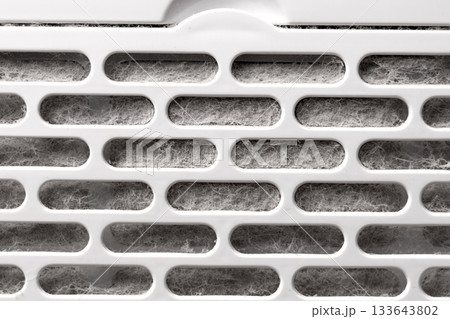 Dirty dusty filter grill of a home air purifier close up. Maintenance service concept 133643802