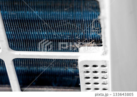 Close-up of dust fibers on blue metal radiator of home air purifier system Close-up of dust fibers on blue metal radiator of home air purifier system 133643805