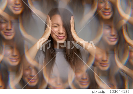 Stressed woman with eyes closed pressing temples showing migraine or headache 133644185