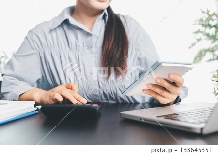 Business woman analyze calculate company financial, tax results office accounting statistics analytical research. calculating business balance prepare tax reduction. Tax deduction planning concept. 133645351
