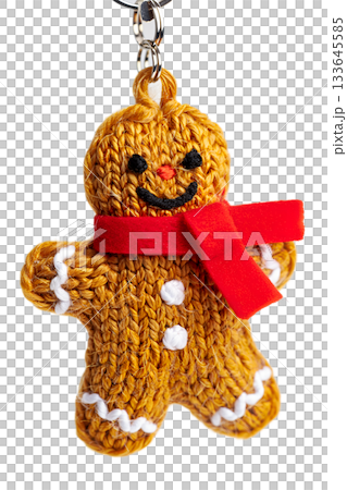 Charming handmade knitted gingerbread man keychain wearing a red scarf, a cute christmas amigurumi toy isolated on transparent background 133645585