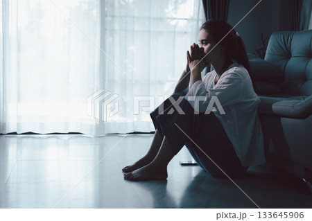 Tired depressed desperate tired girl sadly sitting on couch at home. Young woman is sitting on floor living room, feeling sad and depressed. Psychological problem. Depression and loneliness concept. Tired depressed desperate tired girl sadly sitting on couch at home. Young woman is sitting on floor living room, feeling sad and depressed. Psychological problem. Depression and loneliness concept. 133645906