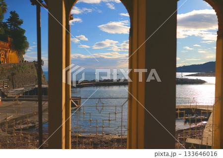 Sea view through arches, Liguria. Panorama in Rapallo, Italy. Traditional buildings, structures, and nature. Sea view through arches, Liguria. Panorama in Rapallo, Italy. Traditional buildings, structures, and nature. 133646016