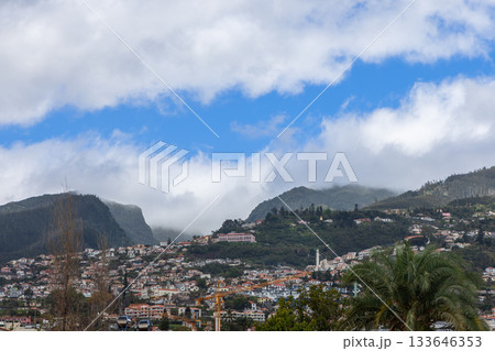Panoramic Funchal landscape with layered neighborhoods misty peaks and tropical vegetation Panoramic Funchal landscape with layered neighborhoods misty peaks and tropical vegetation 133646353