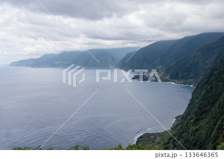 Highlands near Fanal overlook Ribeira da Janela as emerald cliffs meet calm Atlantic sky. Madeira 133646365