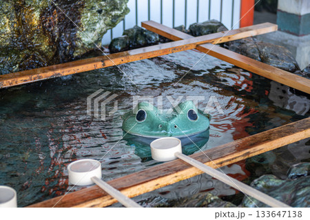 Traditional Japanese water basin with frog sculpture at shrine purification area near Meoto Iwa Futami, Ise city, Japan 133647138
