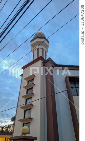 Modern Mosque Minarets and Architecture Against Cloudy Sky 133647208