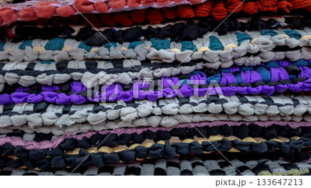 Textured Background of Stacked Black, White, and Red Rag Rugs 133647213