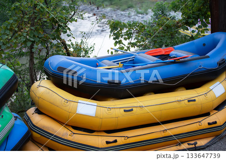 Rubber boats are colorful for rafting. Active recreation during the trip Rubber boats are colorful for rafting. Active recreation during the trip 133647739