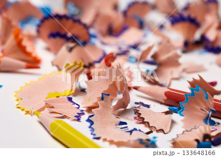 Pencil shavings with colorful lead remnants lying on a white surface 133648166