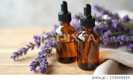 Amber Serum Bottles with Lavender on Oak Wood Amber Serum Bottles with Lavender on Oak Wood 133648444