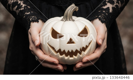 Elegant Hands in Black Lace Holding White Victorian Jack-o-Lantern 133648446