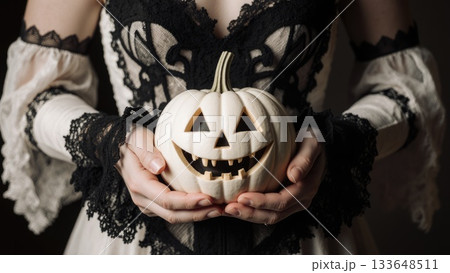 Elegant Hands in Black Lace Holding White Victorian Jack-o-Lantern Elegant Hands in Black Lace Holding White Victorian Jack-o-Lantern 133648511