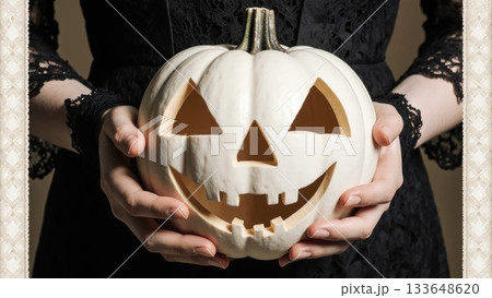 Elegant Hands in Black Lace Holding White Victorian Jack-o-Lantern 133648620