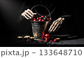 Elegant Skeletal Hands Arranging Dark Candy on Velvet Halloween 133648710