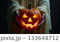 Ghost Hands Holding Glowing Jack-o-Lantern Pumpkin with Spooky Light 133648712