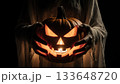 Ghost Hands Holding Glowing Jack-o-Lantern Pumpkin with Spooky Light 133648720