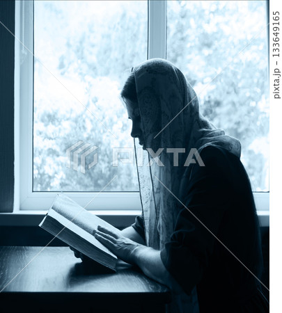 Young woman reading the old book Young woman reading the old book 133649165