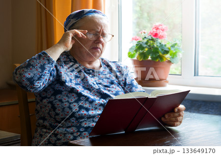 Old woman with big bpook 133649170