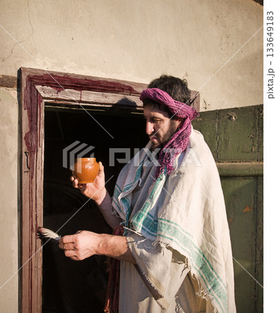 Man painting door with blood Man painting door with blood 133649183