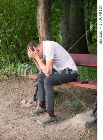 Sad guy on the park bench 133649187