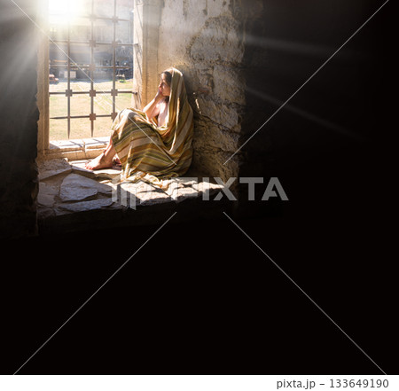 Lone girl sitting in the castle 133649190