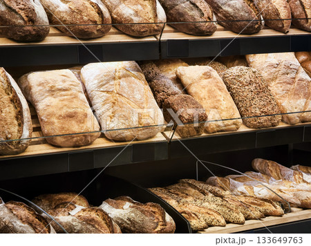Freshly baked bread displayed in a cozy bakery showcasing artisanal loaves and rustic varieties 133649763