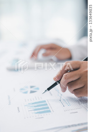 Concept of financial planning and accounting. A businesswoman uses a calculator to analyze reports and charts, calculating budget and investment strategy with focus and precision at office desk. Concept of financial planning and accounting. A businesswoman uses a calculator to analyze reports and charts, calculating budget and investment strategy with focus and precision at office desk. 133649835