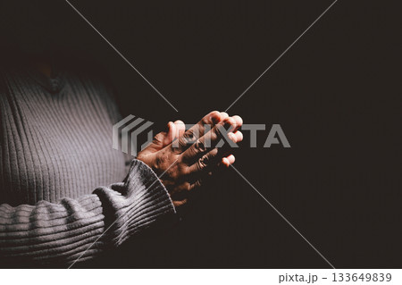 Person holding hands together in prayer gesture, symbolizing hope, faith, meditation, spirituality, trust, belief, peace, devotion, inner strength and resilience during hard times. 133649839