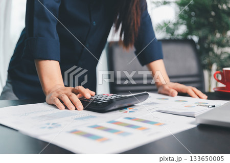 Business woman analyze calculate company financial, tax results office accounting statistics analytical research. calculating business balance prepare tax reduction. Tax deduction planning concept. 133650005