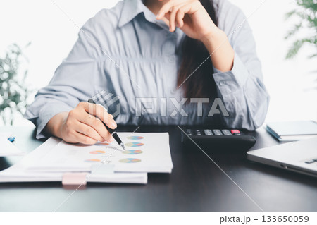 Business woman analyze calculate company financial, tax results office accounting statistics analytical research. calculating business balance prepare tax reduction. Tax deduction planning concept. 133650059