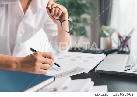 Business woman analyze calculate company financial, tax results office accounting statistics analytical research. calculating business balance prepare tax reduction. Tax deduction planning concept. 133650062