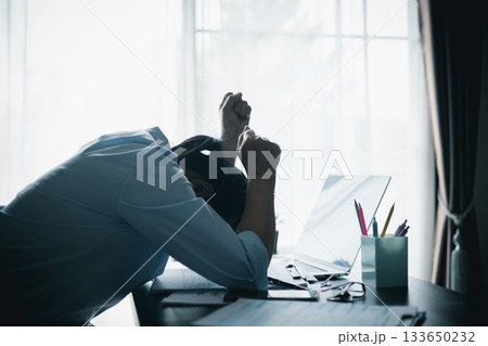 Stressed businesswoman working late at home office, feeling exhausted while reviewing financial documents on laptop. Concept of work stress, burnout, deadline and overwork. Stressed businesswoman working late at home office, feeling exhausted while reviewing financial documents on laptop. Concept of work stress, burnout, deadline and overwork. 133650232