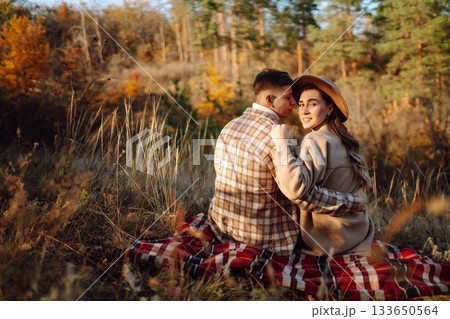 Stylish couple walking and enjoying autumn weather. People, lifestyle, vacations concept. Autumn. 133650564