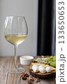 Elegant wine and cheese board with grapes and nuts on rustic wooden table 133650653